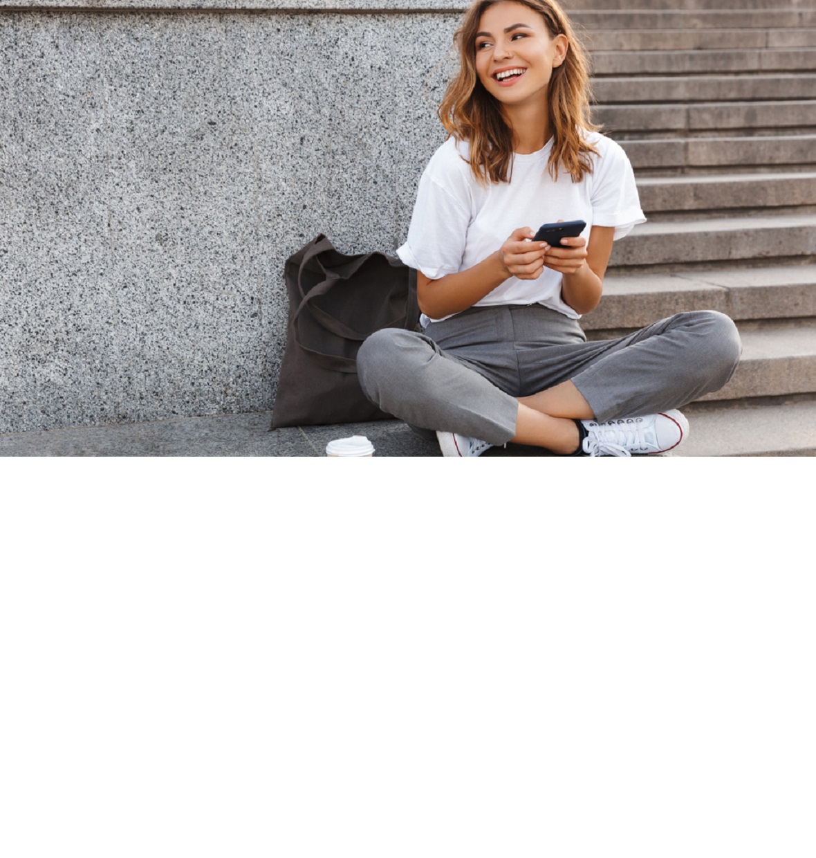 girl smiling down at her laptop