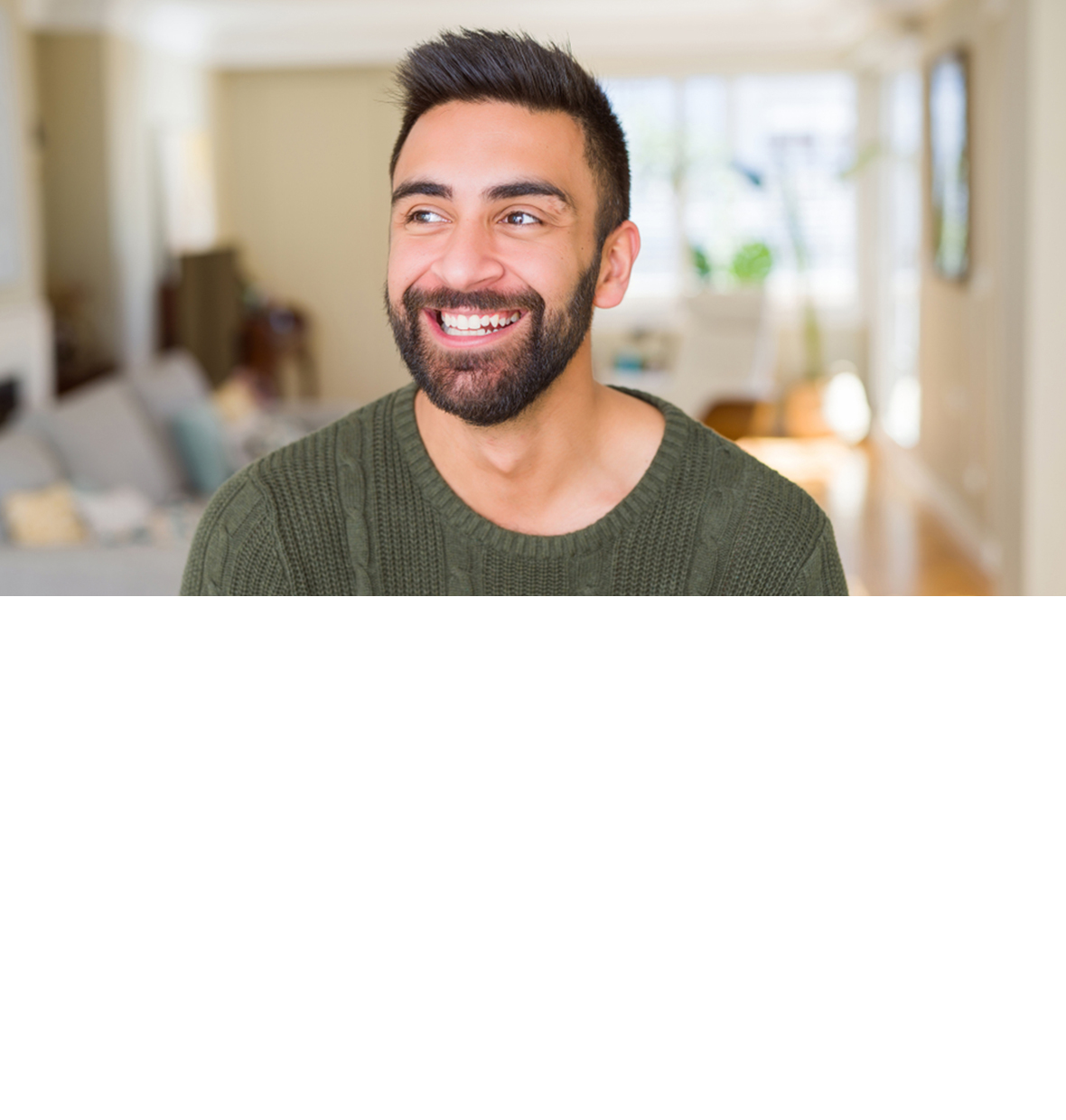 Man with beard smiling to his right